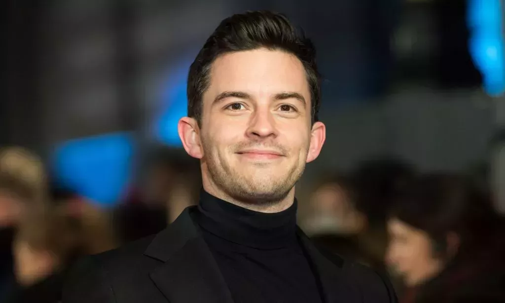 Jonathan Bailey in a black roll-neck and blazer.