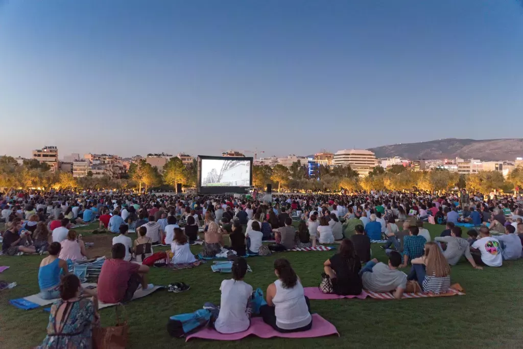 A free open-air cinema, views sitting on blankets on the grass to enjoy the viewing.