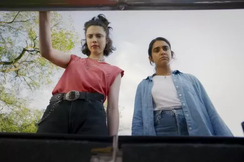 Drive-Away Dolls still; two women looking into a car boot