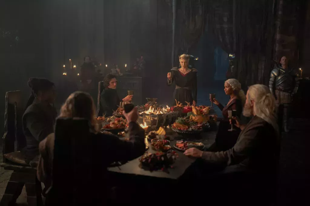 Rhaenyra raising a glass at a banquet