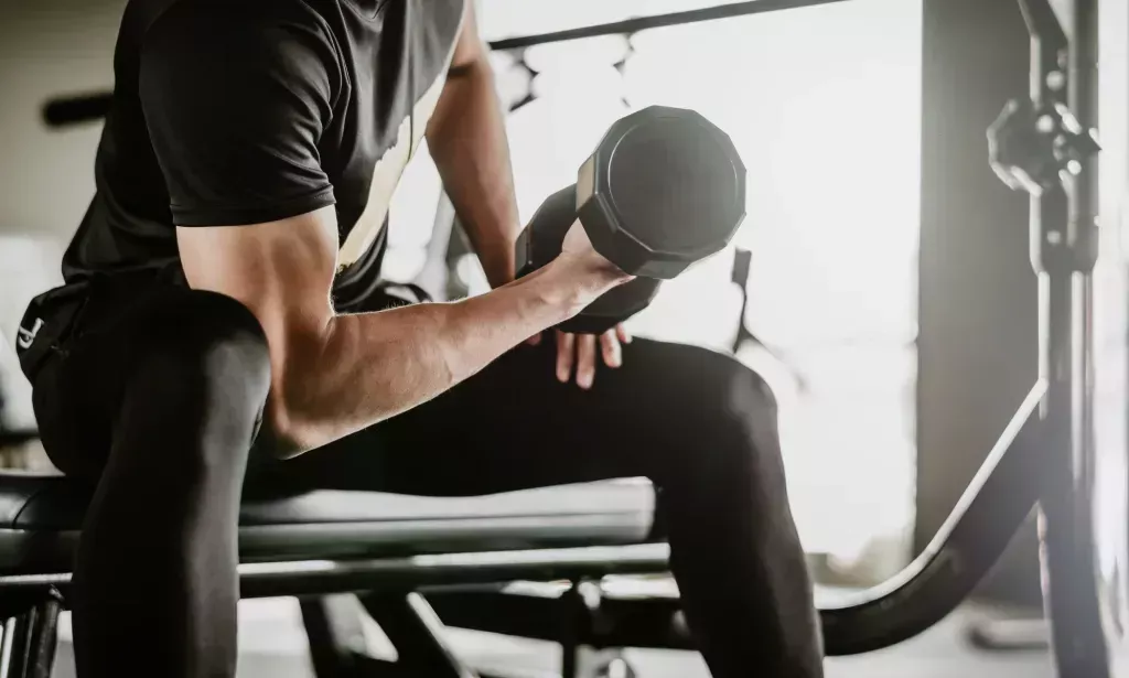 A person lifting a small dumbell.