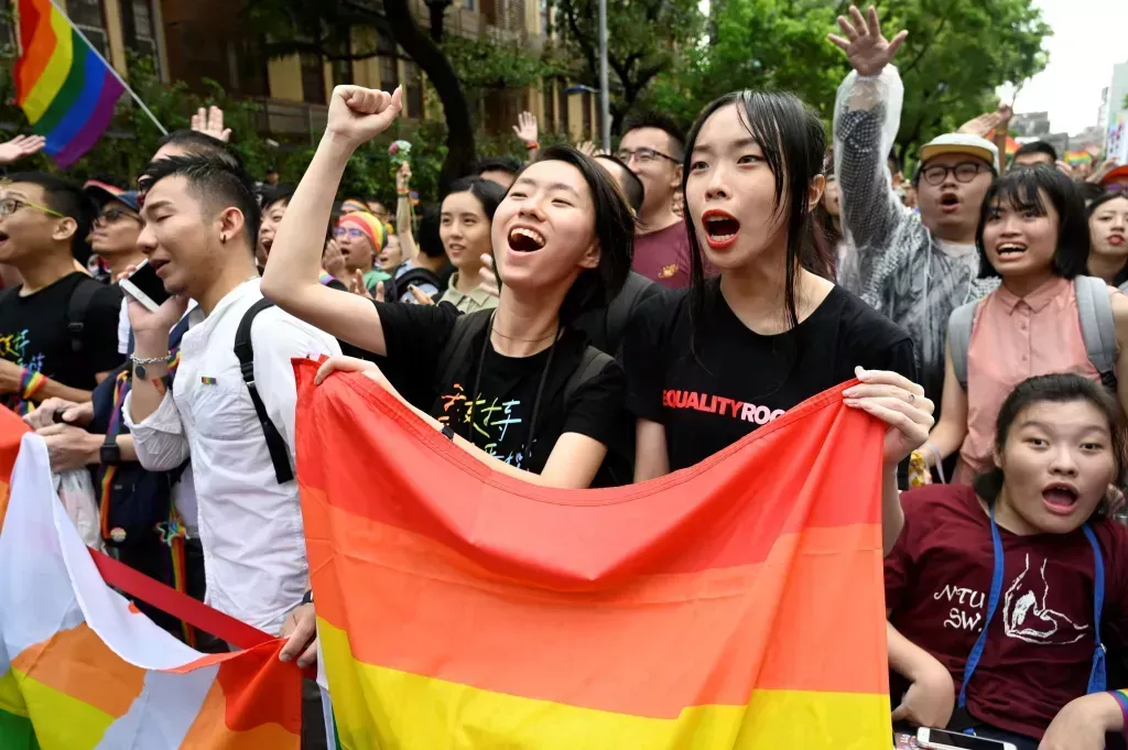 Supporters of same-sex marriage celebrate outside the parliament in Taipei on May 17, 2019. - Taiwan's parliament legalised same-sex marriage on May 17, 2019, in a landmark first for Asia as the government survived a last-minute attempt by conservatives to pass watered-down legislation.