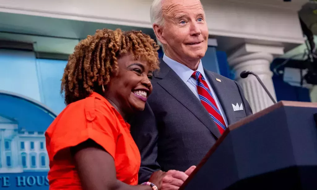 Karine Jean Pierre with Joe Biden at a press conference. 